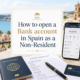 How to open a Bank account in Spain as a Non-Resident shown in a light and modern featured image with passport, bank card, smartphone and Spanish coastal background