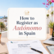 How to Register as Autónomo in Spain shown in a light and modern featured image with paperwork, laptop, smartphone