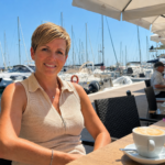 Susan Jordan, editor at startlifeinspain.com, sitting at a sunny cafe by Fuengirola marina on the Costa del Sol